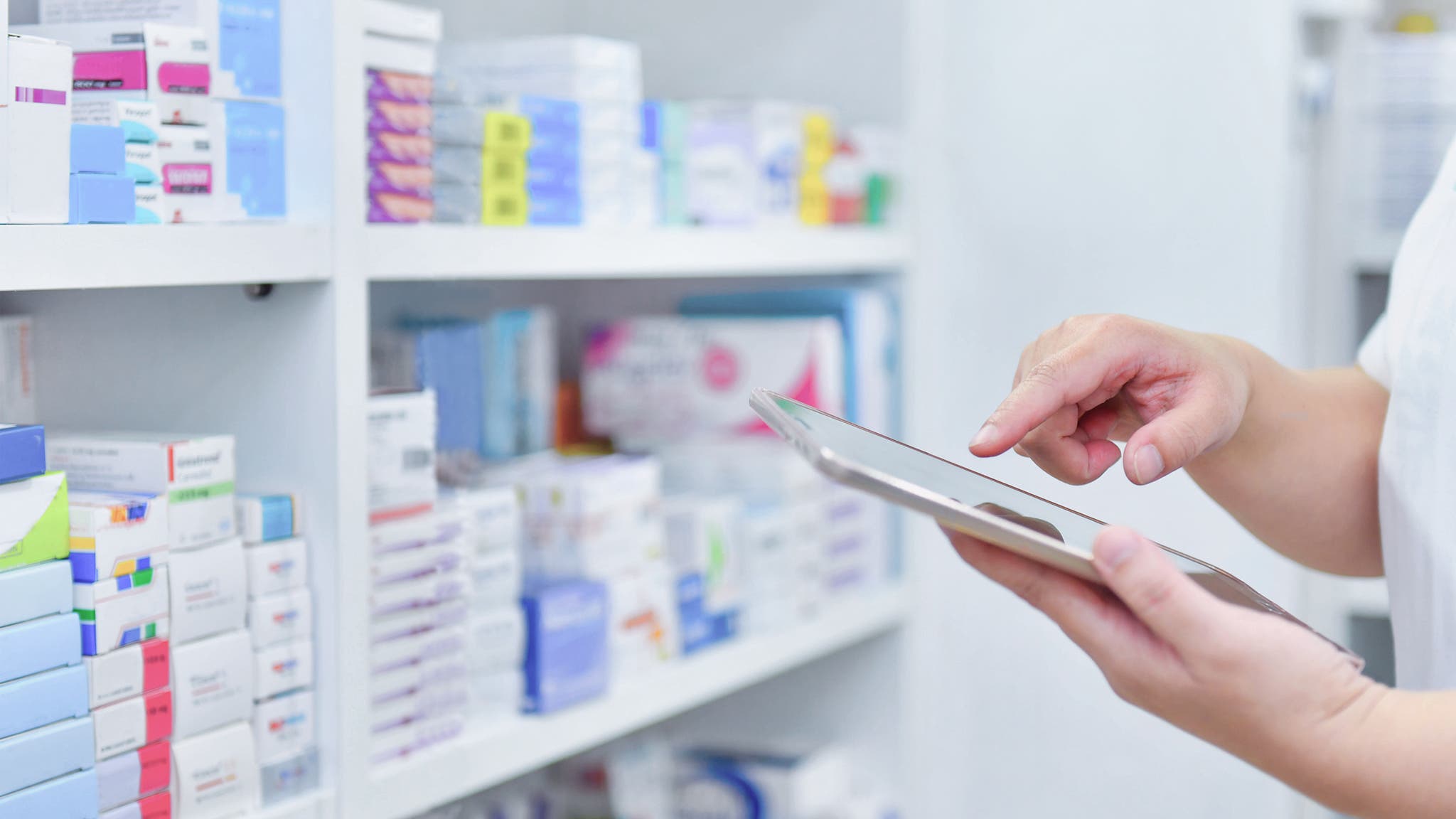 pharmacy automation, Pharmacist holding computer tablet, Using for filling prescription in pharmacy drugstore. 