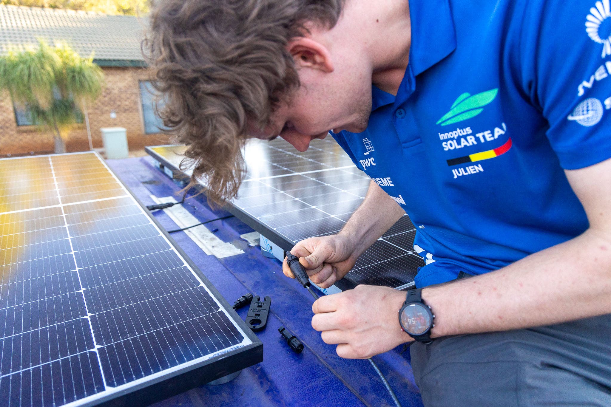 Student installing a connector on the container roof.